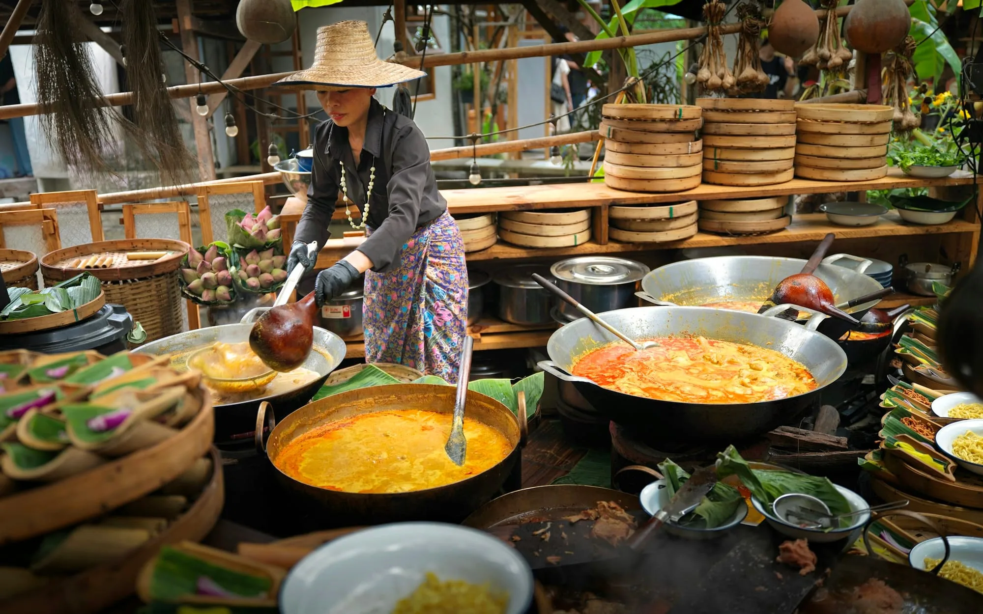 A cook stirring curry at a market stall in Chiang Mai