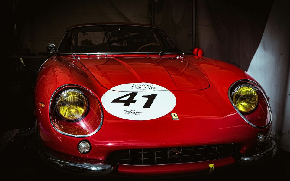 A red classic Ferrari racing car carrying the number 41