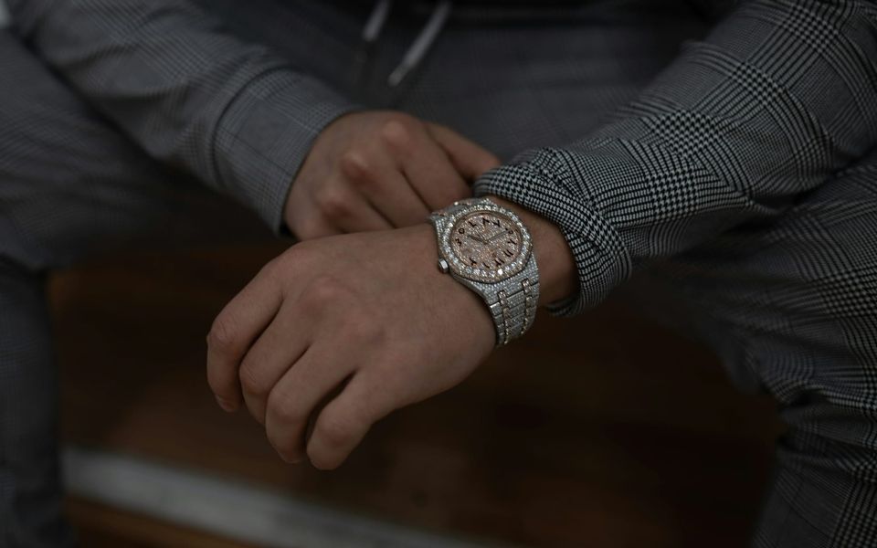 An Audemars Piguet chronograph on a seated man’s wrist