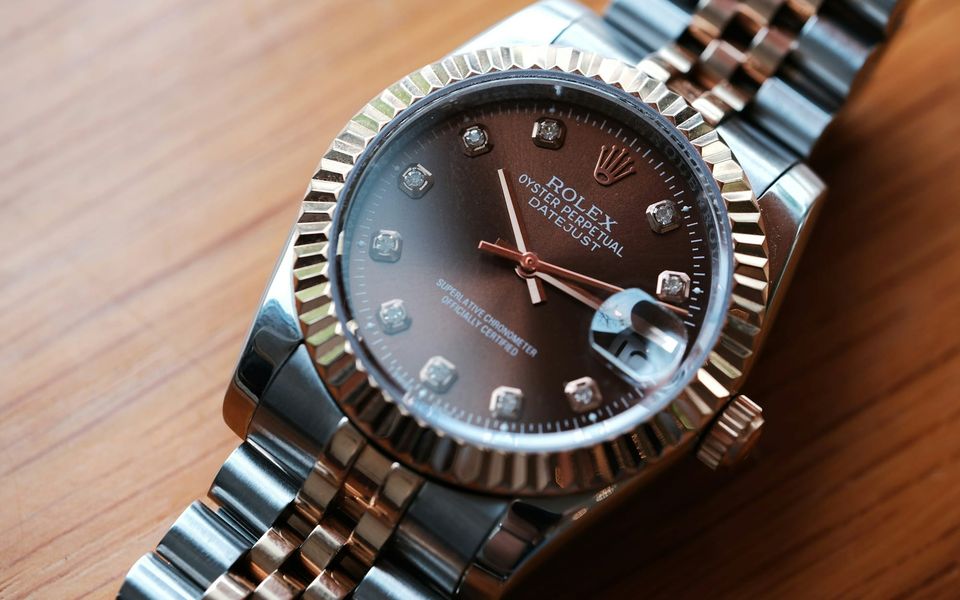 A two-tone Rolex Datejust with a brown dial