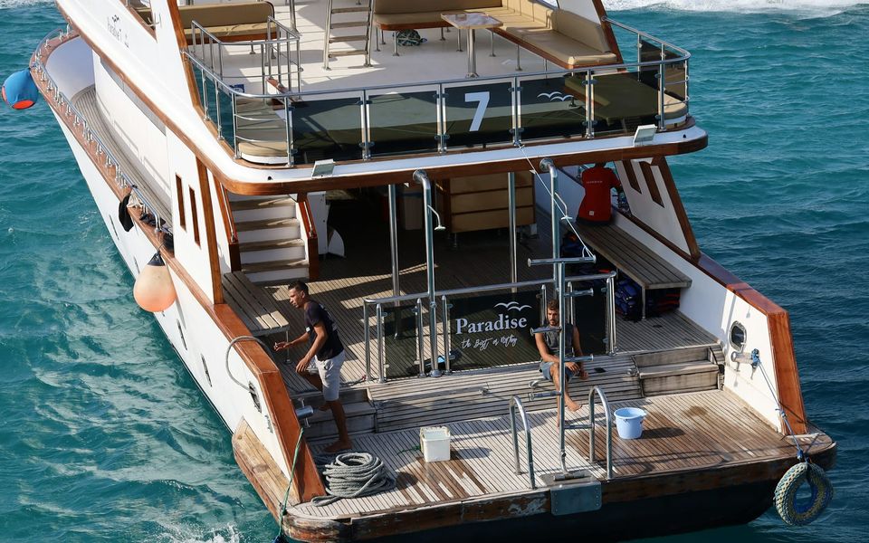 Crew at work on the aft deck of a motor yacht