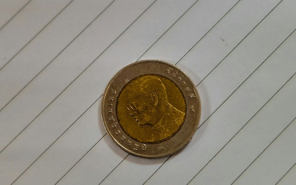 Thai 10-baht coin on lined paper